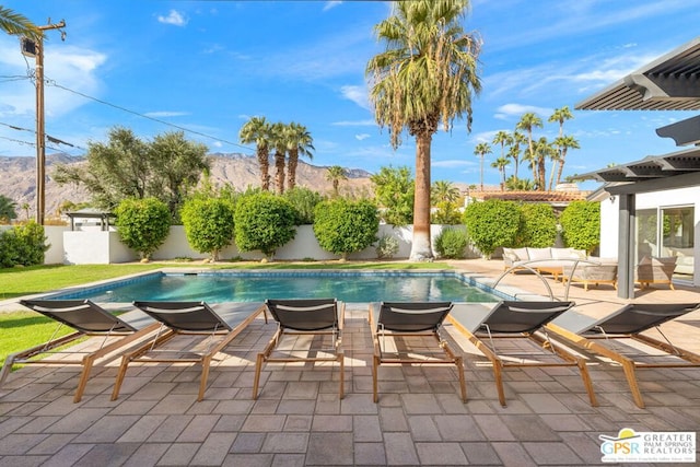 view of swimming pool featuring an outdoor living space, a mountain view, a patio area, and a pergola