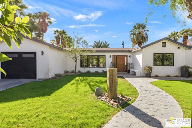 ranch-style home featuring a garage and a front yard