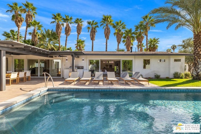 view of pool with a patio and ceiling fan