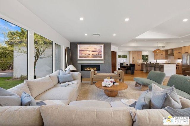 living room with light hardwood / wood-style flooring and a wealth of natural light