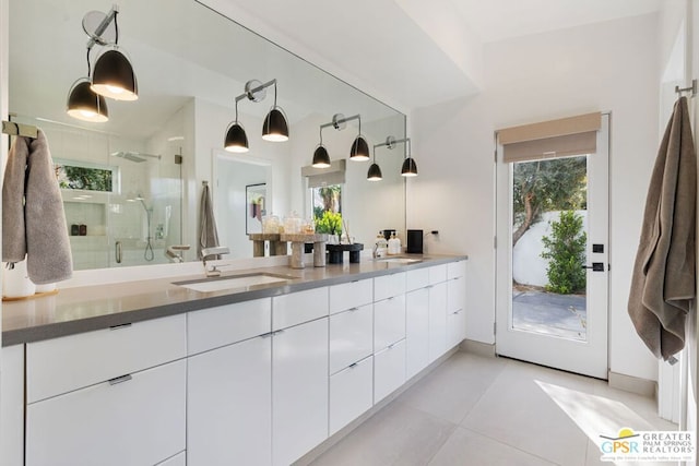 bathroom with vanity, an enclosed shower, tile patterned floors, and a healthy amount of sunlight