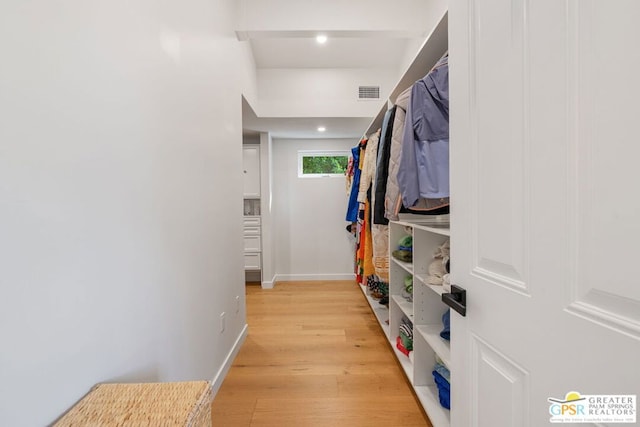 spacious closet featuring light hardwood / wood-style flooring