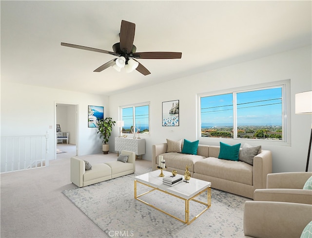 living room featuring a wealth of natural light, carpet, and ceiling fan