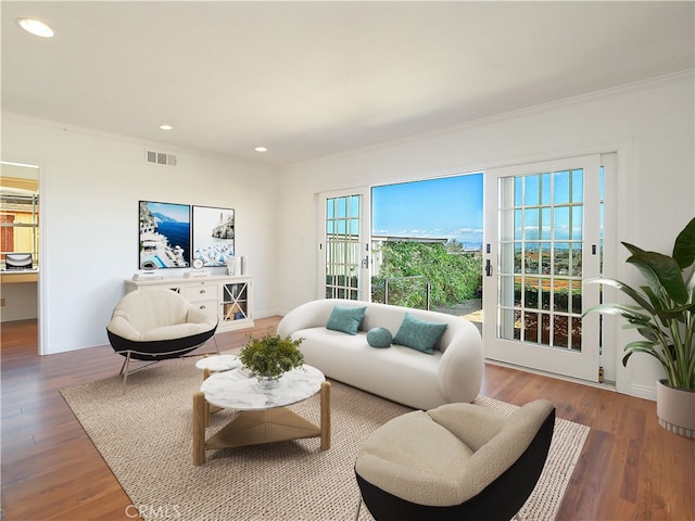 living room featuring hardwood / wood-style floors and ornamental molding