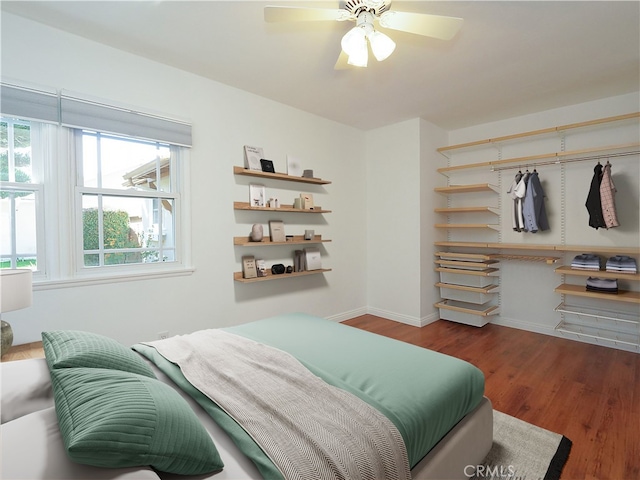 bedroom featuring ceiling fan and dark hardwood / wood-style floors