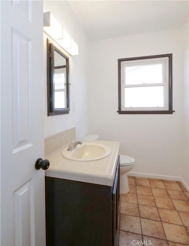 bathroom featuring tile patterned floors, vanity, and toilet