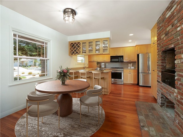 dining room featuring dark hardwood / wood-style flooring and sink