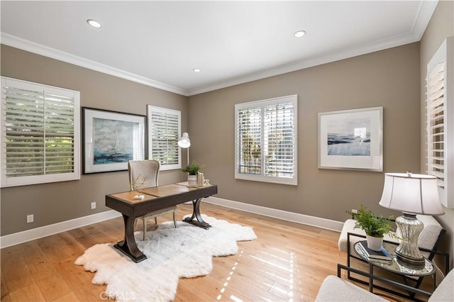 office with light hardwood / wood-style floors and ornamental molding