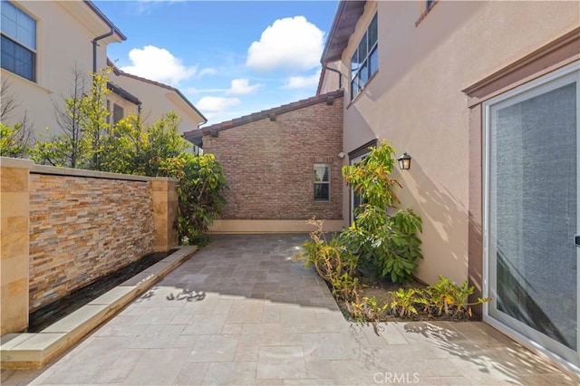 view of side of property with a patio