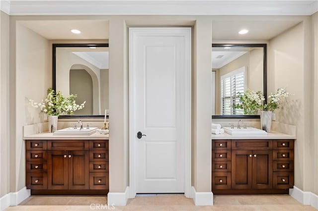 bathroom with tile patterned flooring, vanity, and crown molding