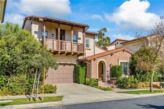 mediterranean / spanish-style house featuring a balcony and a garage