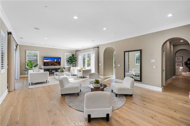 living room featuring crown molding and light hardwood / wood-style flooring