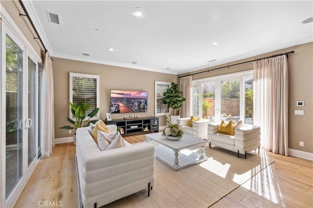 living room with french doors, light wood-type flooring, and crown molding