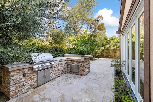 view of patio with area for grilling and exterior kitchen