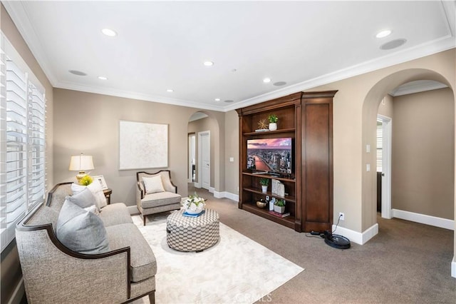 carpeted living room with crown molding