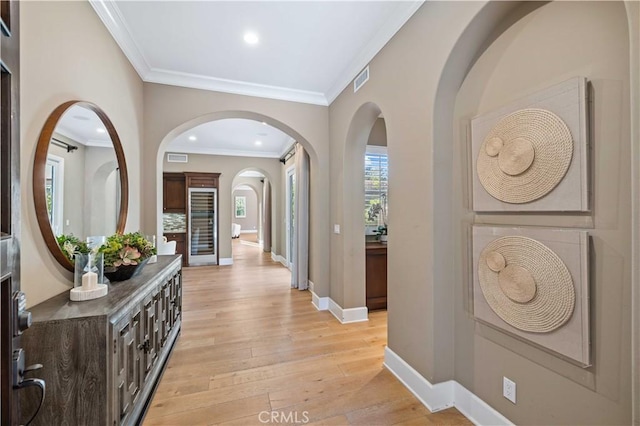 corridor featuring light hardwood / wood-style floors and ornamental molding