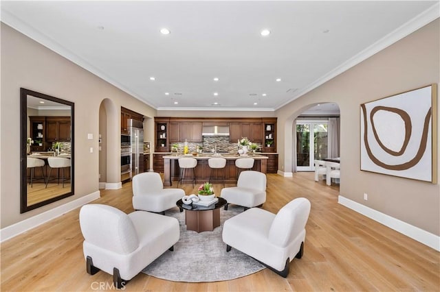 living room with light hardwood / wood-style flooring and ornamental molding