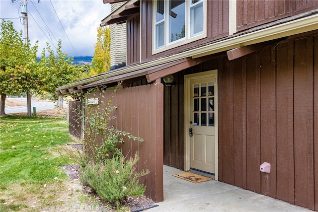 doorway to property with a yard