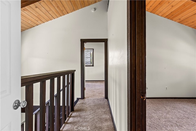 hallway with lofted ceiling, carpet flooring, and wood ceiling