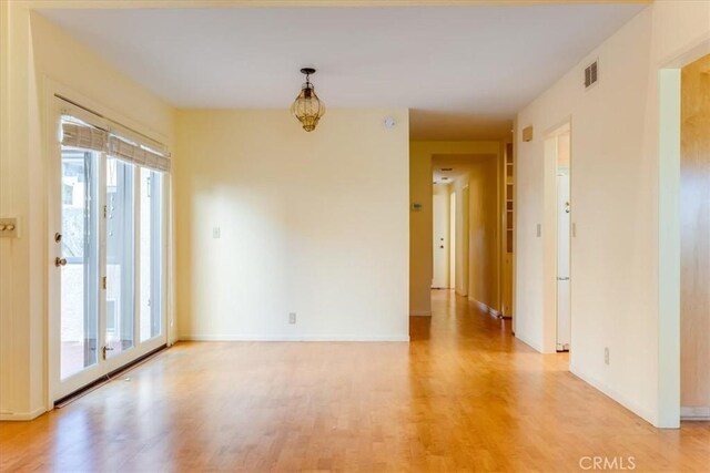 spare room with wood-type flooring