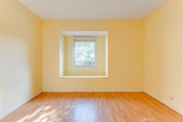 spare room featuring hardwood / wood-style flooring