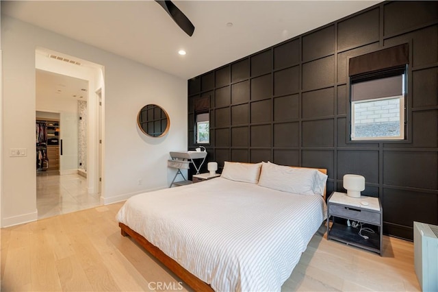 bedroom with ceiling fan and light hardwood / wood-style floors