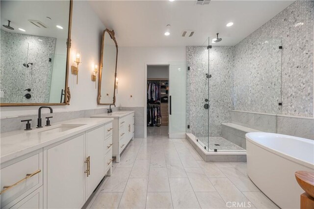 bathroom featuring vanity and separate shower and tub