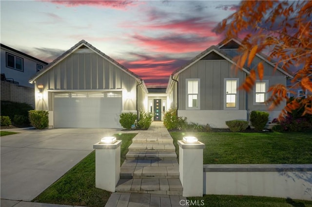 view of front of home with a yard and a garage