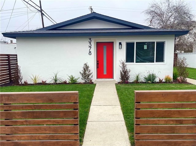 bungalow-style house with a front yard