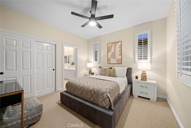 carpeted bedroom featuring ceiling fan and connected bathroom