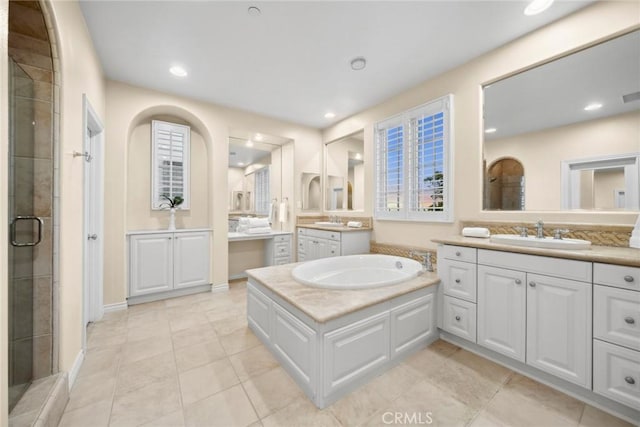 bathroom featuring tile patterned floors, a shower with door, and vanity