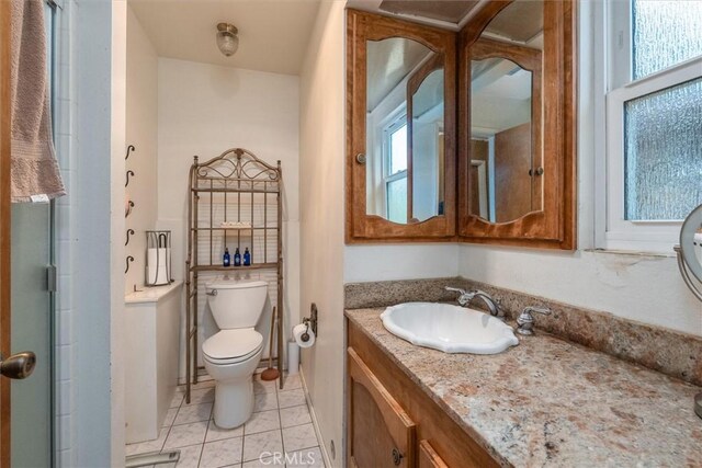 44739 Rd 619, Ahwahnee, CA 93601 - bathroom featuring vanity, tile patterned flooring, a shower with door, and toilet