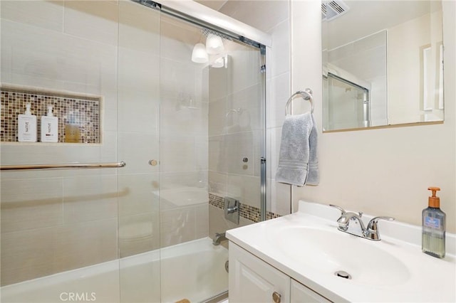 bathroom with enclosed tub / shower combo and vanity