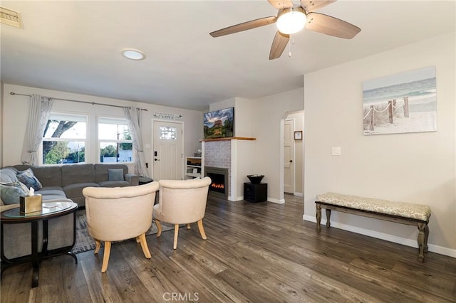 living room with ceiling fan and dark hardwood / wood-style flooring