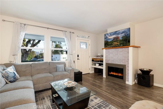 living room with a fireplace and dark hardwood / wood-style floors