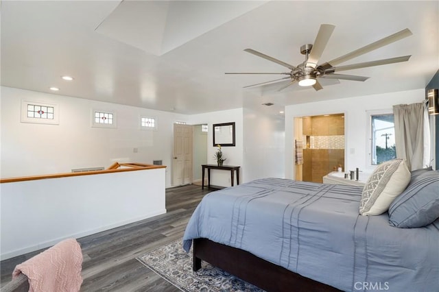 bedroom featuring ceiling fan, ensuite bath, and dark hardwood / wood-style floors