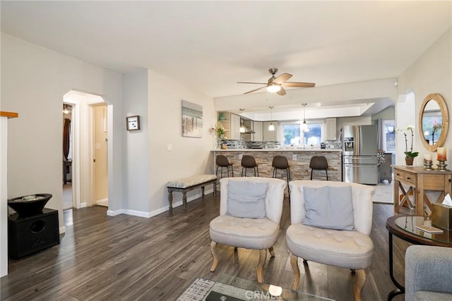 living room featuring ceiling fan and dark hardwood / wood-style flooring