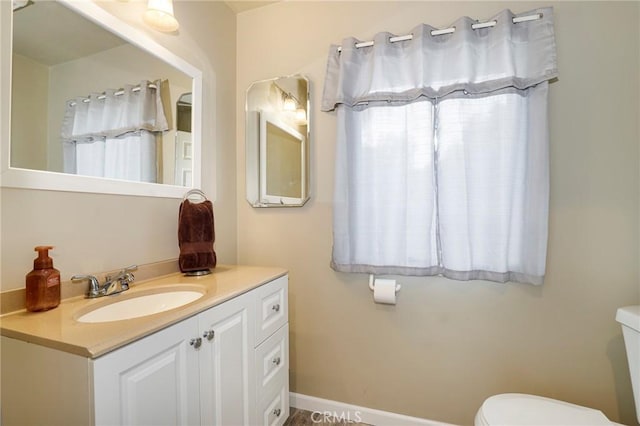 bathroom featuring toilet and vanity