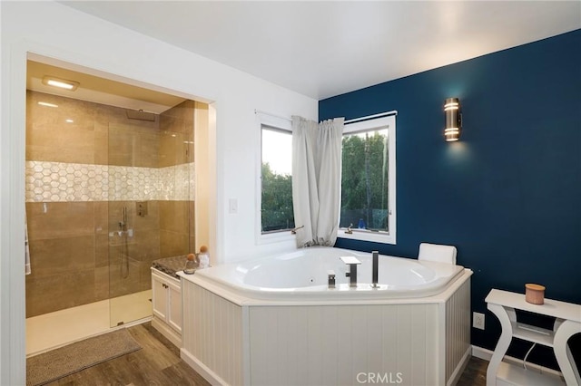 bathroom with hardwood / wood-style flooring and separate shower and tub