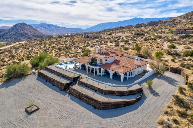 birds eye view of property with a mountain view