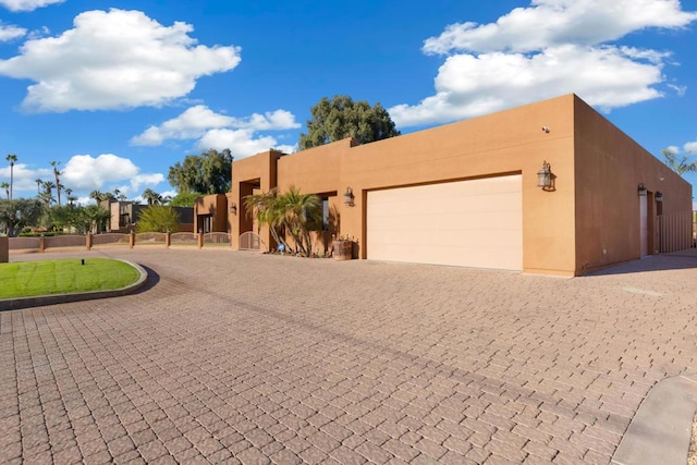 pueblo-style house with a garage