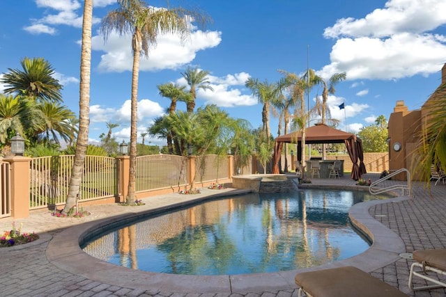 view of pool with an in ground hot tub, a gazebo, and a patio