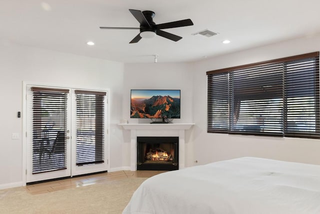 tiled bedroom featuring ceiling fan and access to exterior