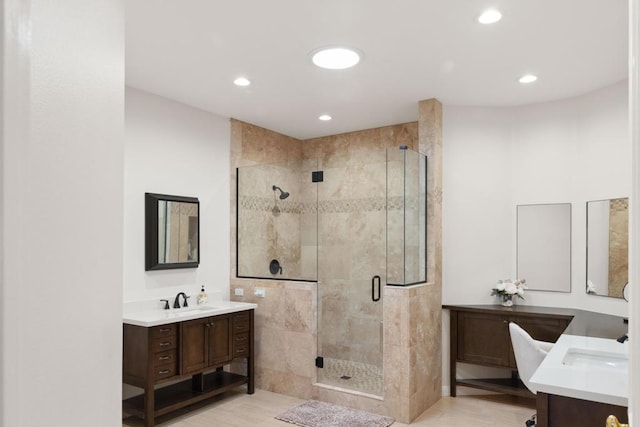 bathroom featuring vanity and a shower with shower door