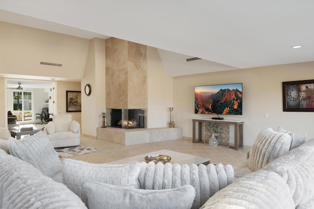 living room with ceiling fan and a multi sided fireplace