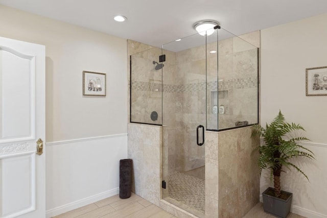 bathroom with a shower with door