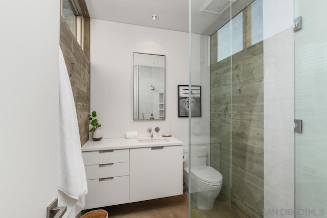 bathroom with vanity, toilet, and an enclosed shower