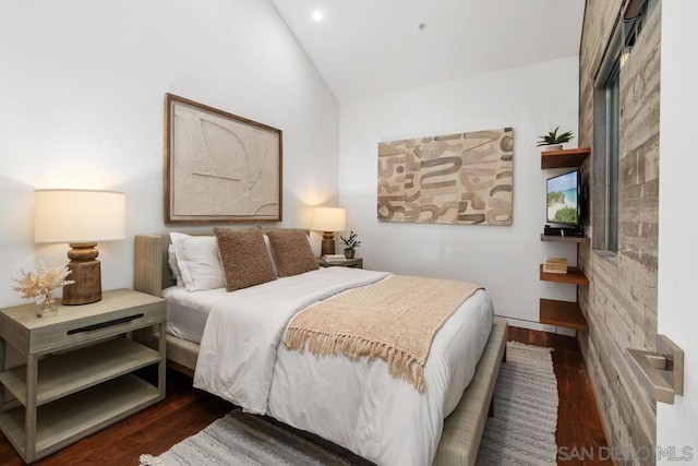 bedroom featuring lofted ceiling and dark wood-type flooring