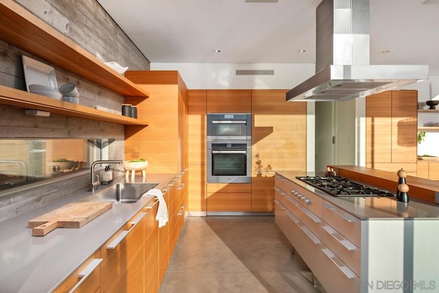 kitchen featuring island exhaust hood, sink, stainless steel counters, and stainless steel appliances