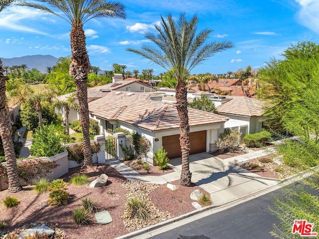 view of front of property with a mountain view and a garage